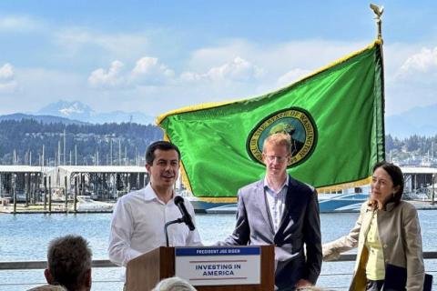 Secretary Buttigieg speaking alongside Senator Maria Cantwell (D-WA) and Rep. Derek Kilmer (WA-06)