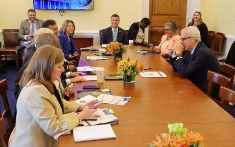 Secretary McDonough and members of the RLC at a table.
